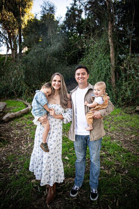 Jon and Debbie Gryn holding their two sons in a eucalyptus grove