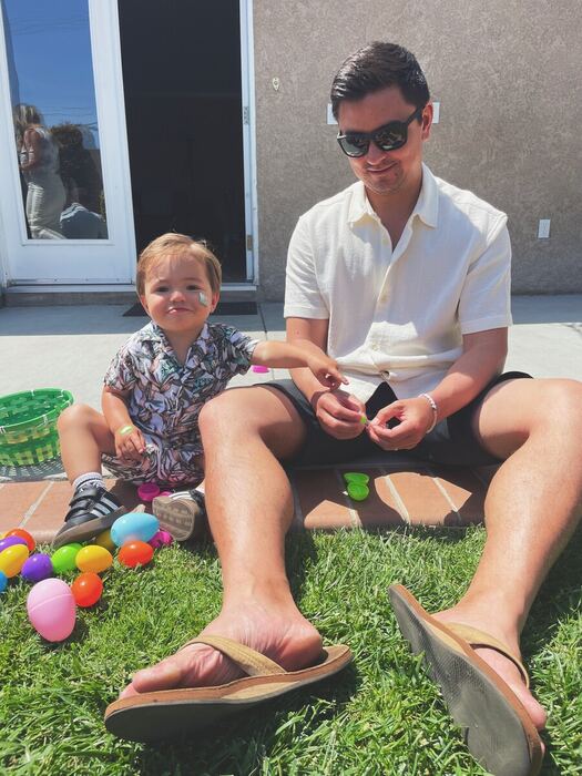 Jon and his son decorating Easter eggs together in the backyard